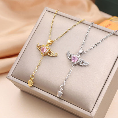 Amorital angel wings necklace with pink heart crystal — gold and silver pendant symbolizing love, luck, purity, and protection