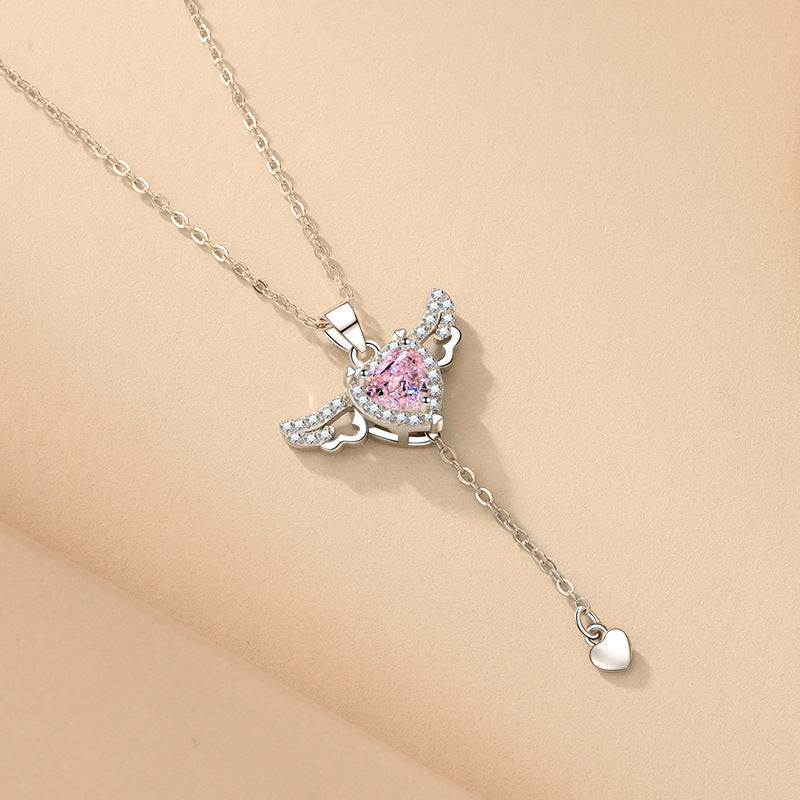 Amorital angel wings necklace with pink heart crystal — gold and silver pendant symbolizing love, luck, purity, and protection