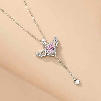 Amorital angel wings necklace with pink heart crystal — gold and silver pendant symbolizing love, luck, purity, and protection