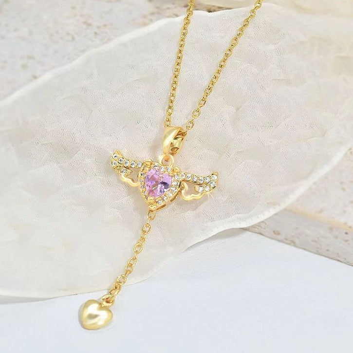 Amorital angel wings necklace with pink heart crystal — gold and silver pendant symbolizing love, luck, purity, and protection